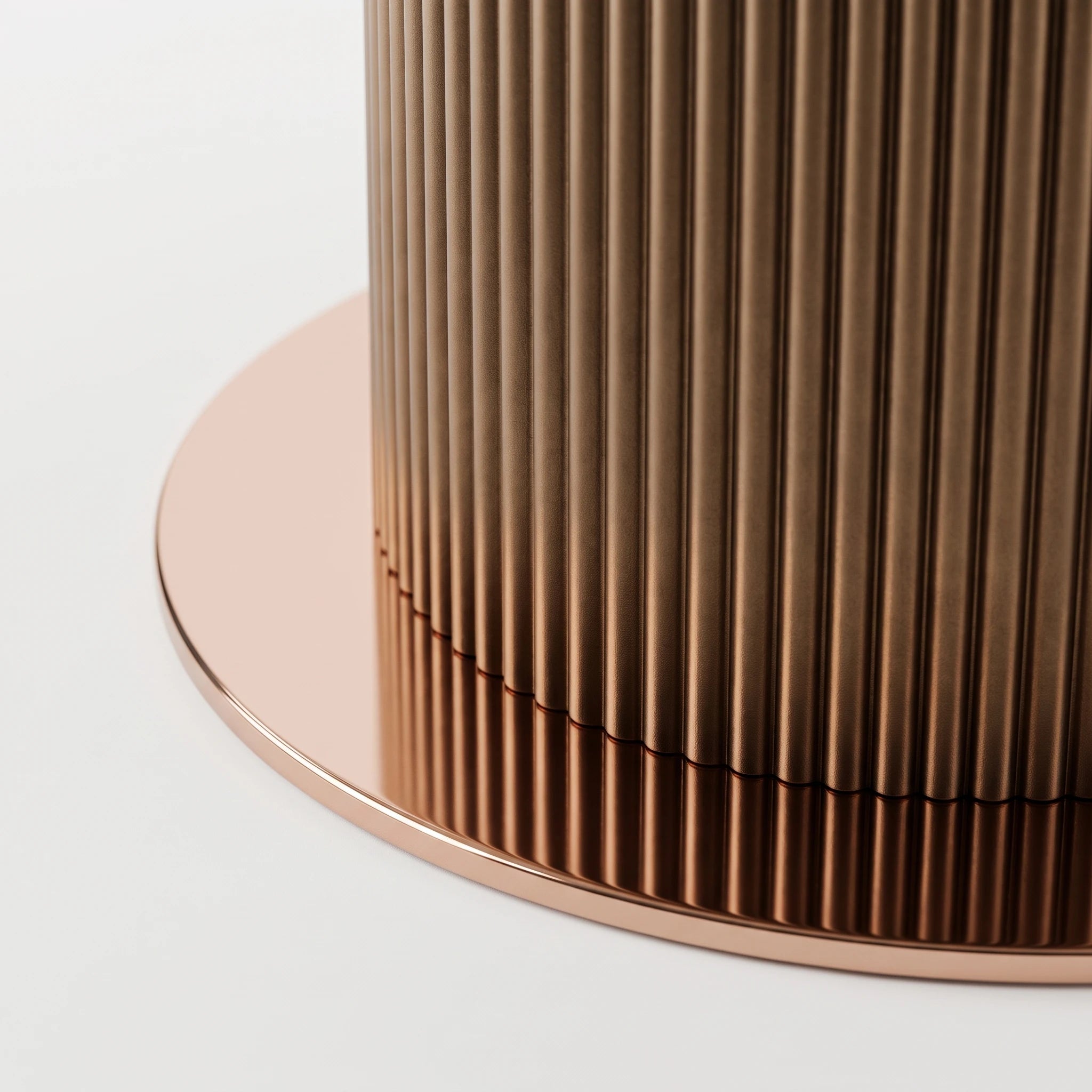 Ariano Dinning Room Table close-up showing fluted bronze metal pedestal base and round tabletop edge.