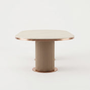 Ariano Dinning Room Table with white marble-look round top and rose gold metal trim on fluted pedestal base.