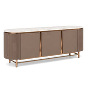 Ariano Sideboard with an oval white marble top, taupe body, fluted ends, and golden metal accents, on slender legs.