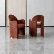Bodrum dining room chair in rust velvet upholstery with a gold metal base and curved back