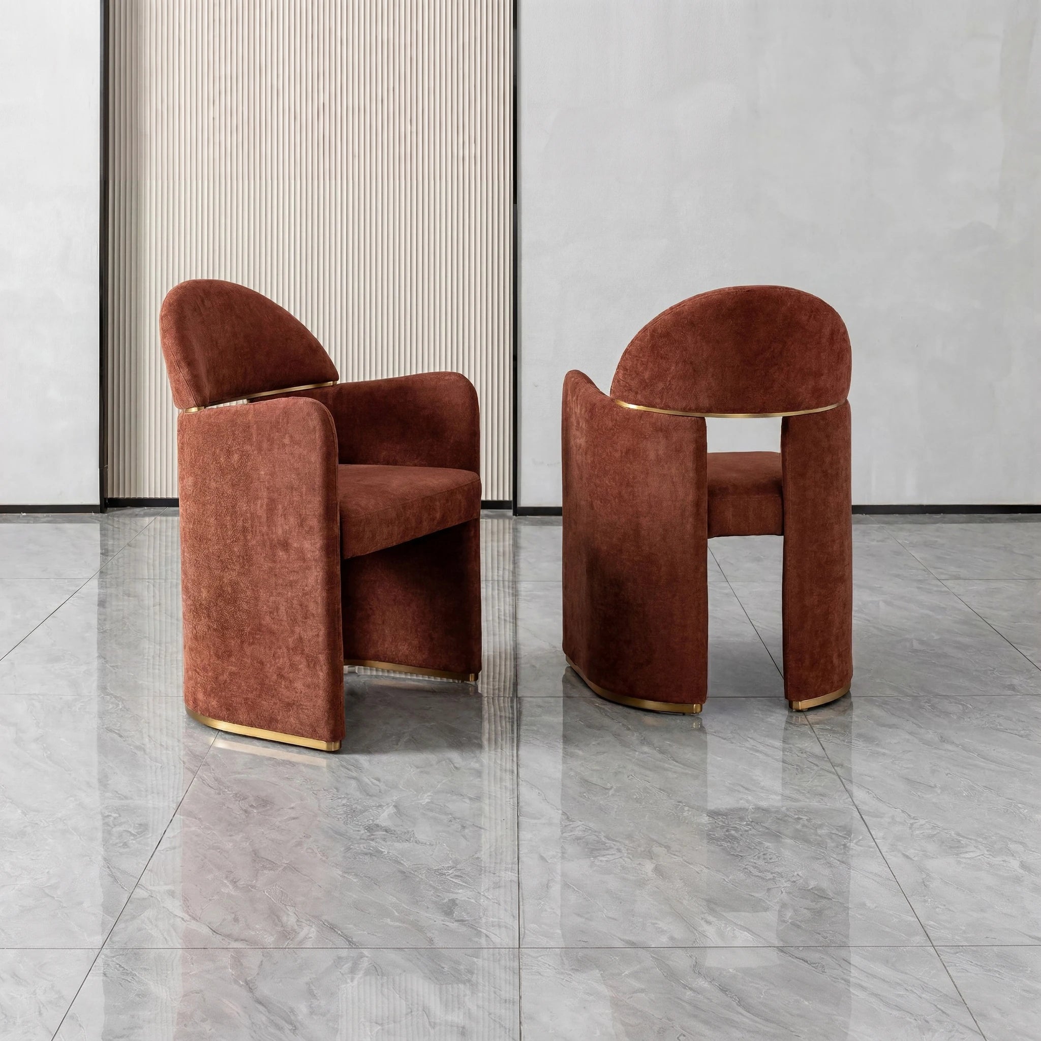 Bodrum dining room chair in rust velvet upholstery with a gold metal base and curved back