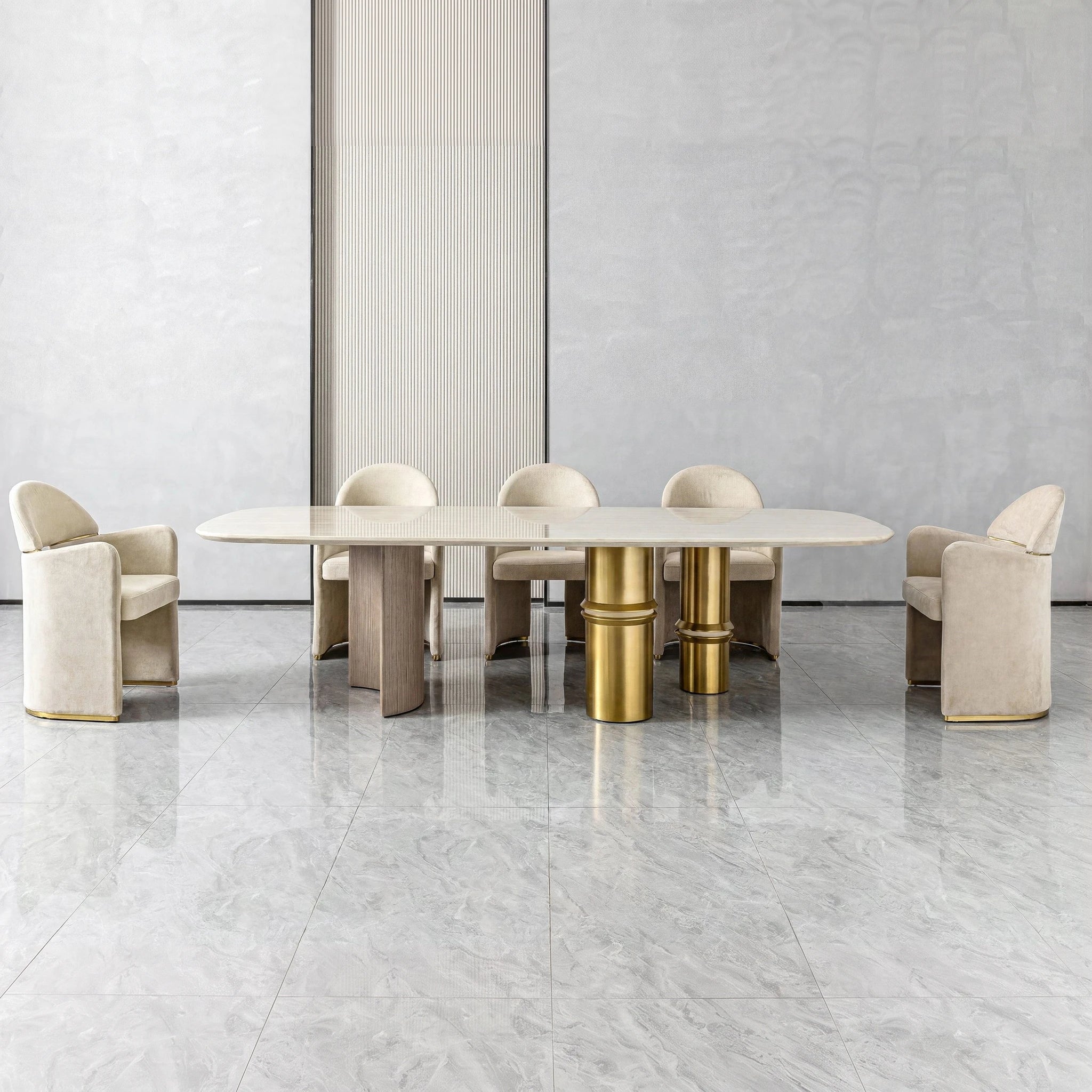 Bodrum Dining Room Table shown with beige upholstered chairs, a light marble tabletop, and gold pedestal bases.