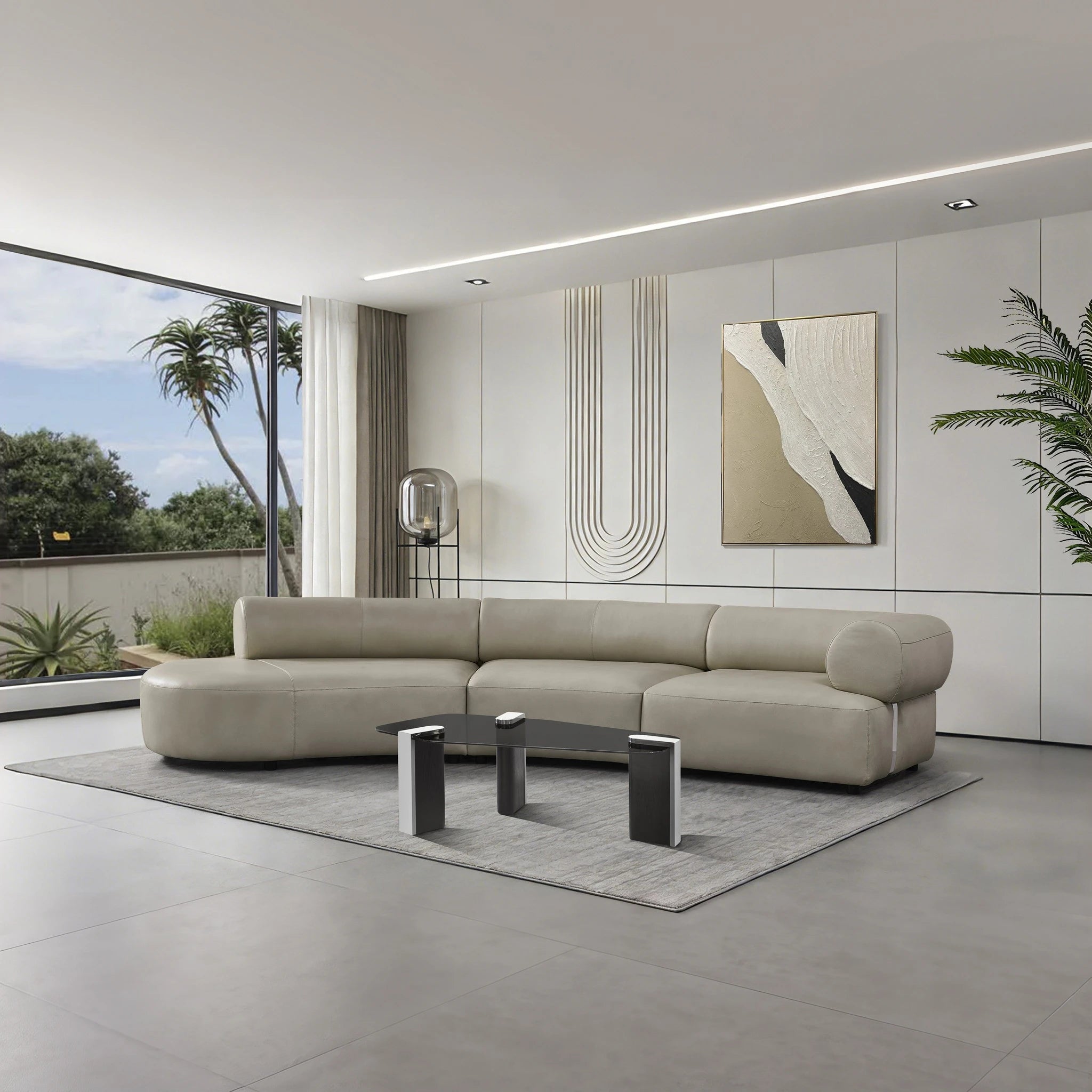 Bologna 3 Seater Sofa in beige leather shown in a modern living room with large windows and neutral decor.