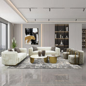 Brittany Coffee Table 2 Piece Set with white marble top and gold round bases in a modern living room.