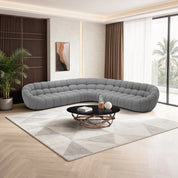 Bubble Sofa in gray with a curved, tufted design; a modern sectional ideal for contemporary living rooms.