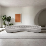 Bubble Sofa in light gray fabric with rounded tufted cushions, placed in a modern living room.