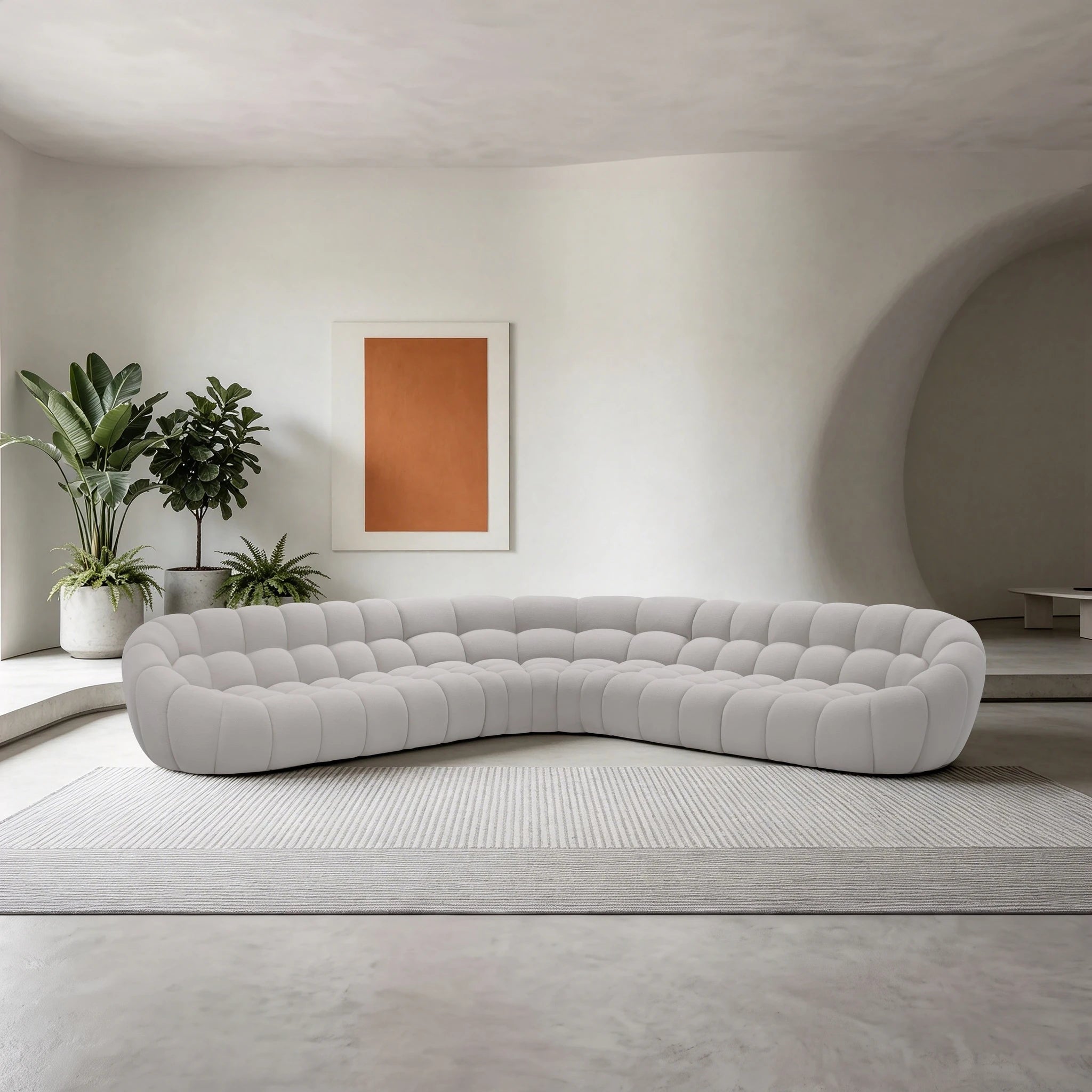Bubble Sofa in light gray fabric with rounded tufted cushions, placed in a modern living room.
