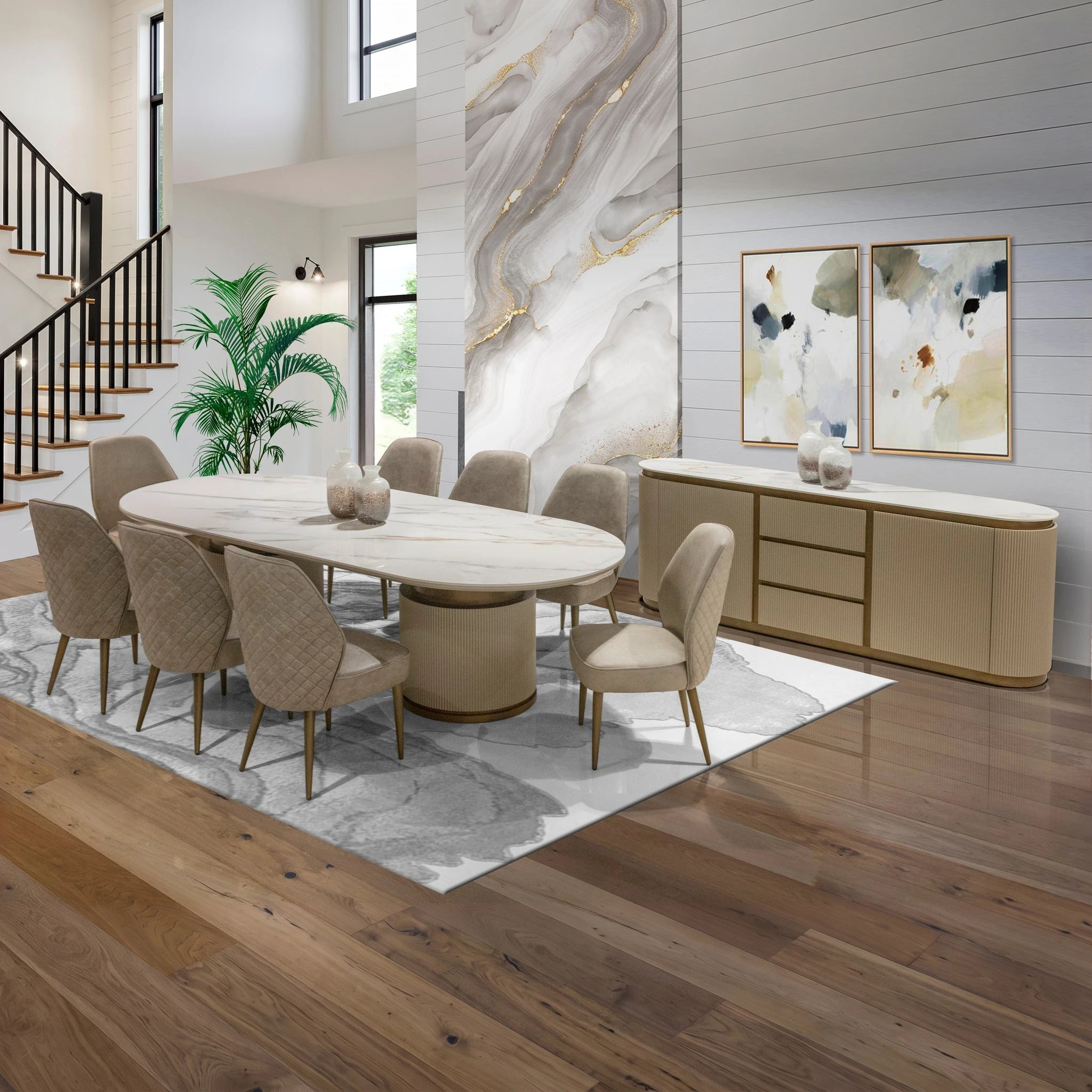 Chandler Dining Room Table with a white marble top and cylindrical beige base, surrounded by quilted beige chairs.