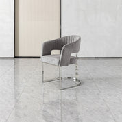Cristallo dining chair featuring gray velvet upholstery, curved back, chrome base, and crystal accents for a luxe look.