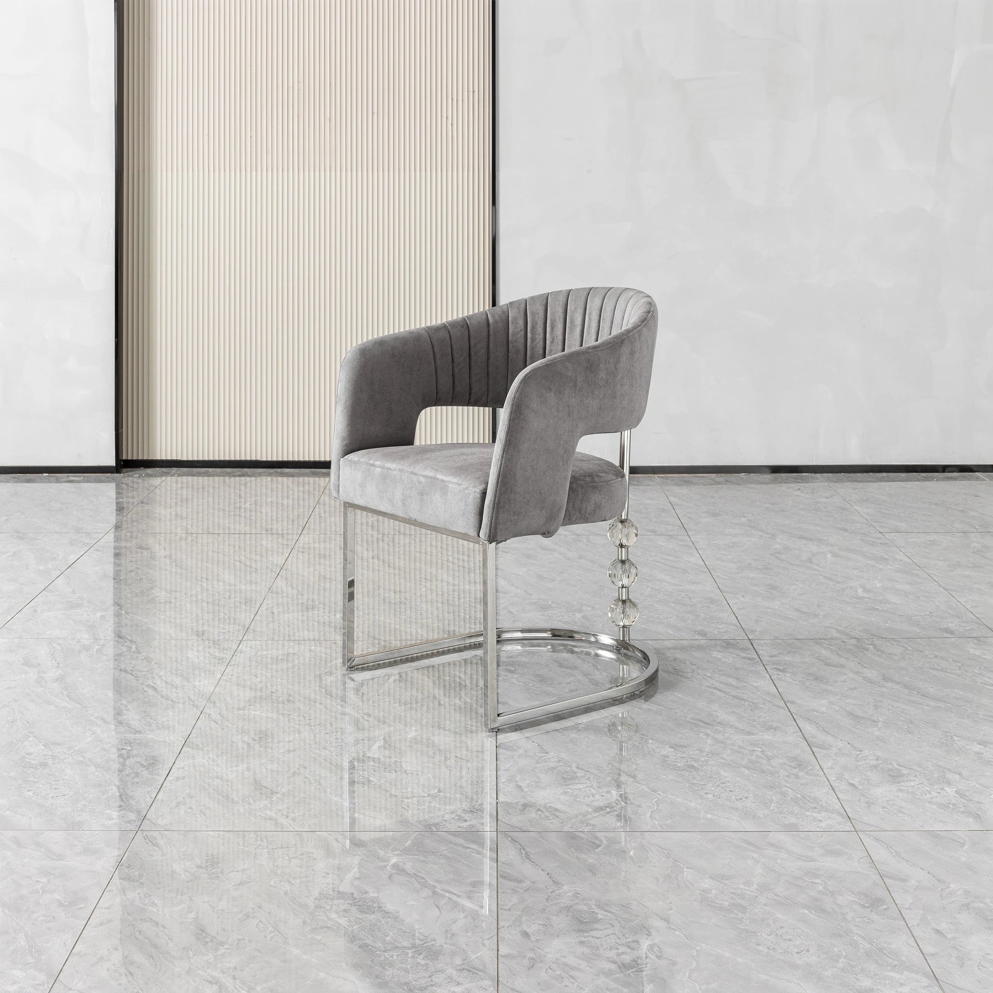 Cristallo dining chair featuring gray velvet upholstery, curved back, chrome base, and crystal accents for a luxe look.