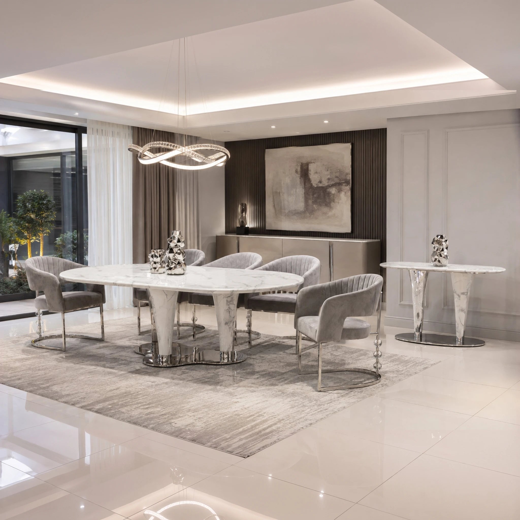 Cristallo dining room table with white marble top and chrome pedestal bases in a modern dining area.