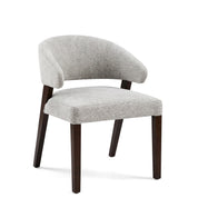 Delphi Dining Room Chair with light gray textured upholstery and dark brown wooden legs, featuring a curved backrest.
