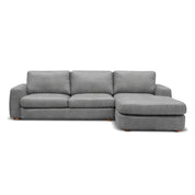 Modern grey fabric Hickory L-Shape Lounge Suite with a chaise lounge, featuring soft cushions and wooden feet.