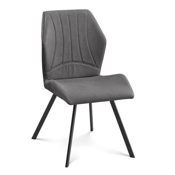 Dark grey upholstered Kali dining chair with a curved backrest, vertical stitching, and sleek black tapered metal legs.