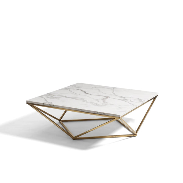 Layla square coffee table with a white marble top and a distinctive gold geometric metal base on a plain background.