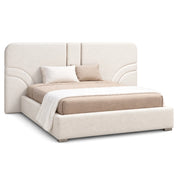 Neutral upholstered Luciana bed with a modern curved headboard, featuring beige bedding and two pillows, presented from a
