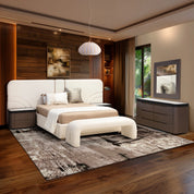 Luciana Ottoman - Neutral in beige fabric with curved profile, shown in a modern bedroom scene.