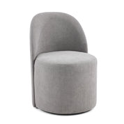 Modern gray upholstered Melrose Dining Room Chair On Wheels, featuring a curved backrest and a round seat, on a plain