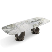 Montpellier Dining Room Table with a rectangular white and grey marble top, supported by two dark curved wooden bases on