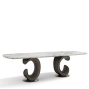 Montpellier Dining Room Table featuring a white marble top and two sculptural dark wood bases, viewed from an angle.