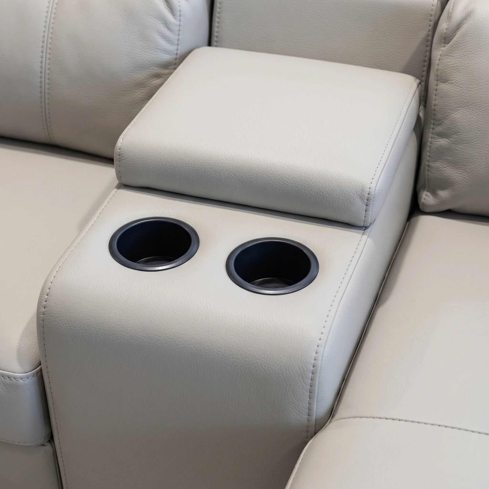 Perissa Corner Lounge Suite Grey 5Pc close-up of grey upholstered armrest console with two built-in cup holders