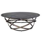 Modern Peyton coffee table featuring a dark gray round glass top and an intricate polished dark metal base.