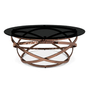 Peyton Coffee Table with a round black glass top and an intricate rose gold metallic crisscross base, viewed from an angle.