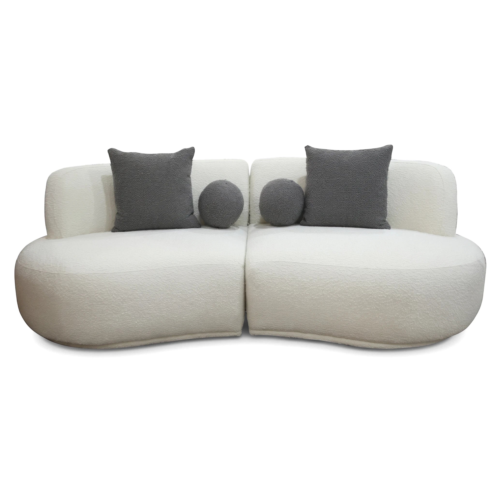 Modern white bouclé Witney Sofa featuring two curved sections and four dark gray throw pillows, viewed from the front.